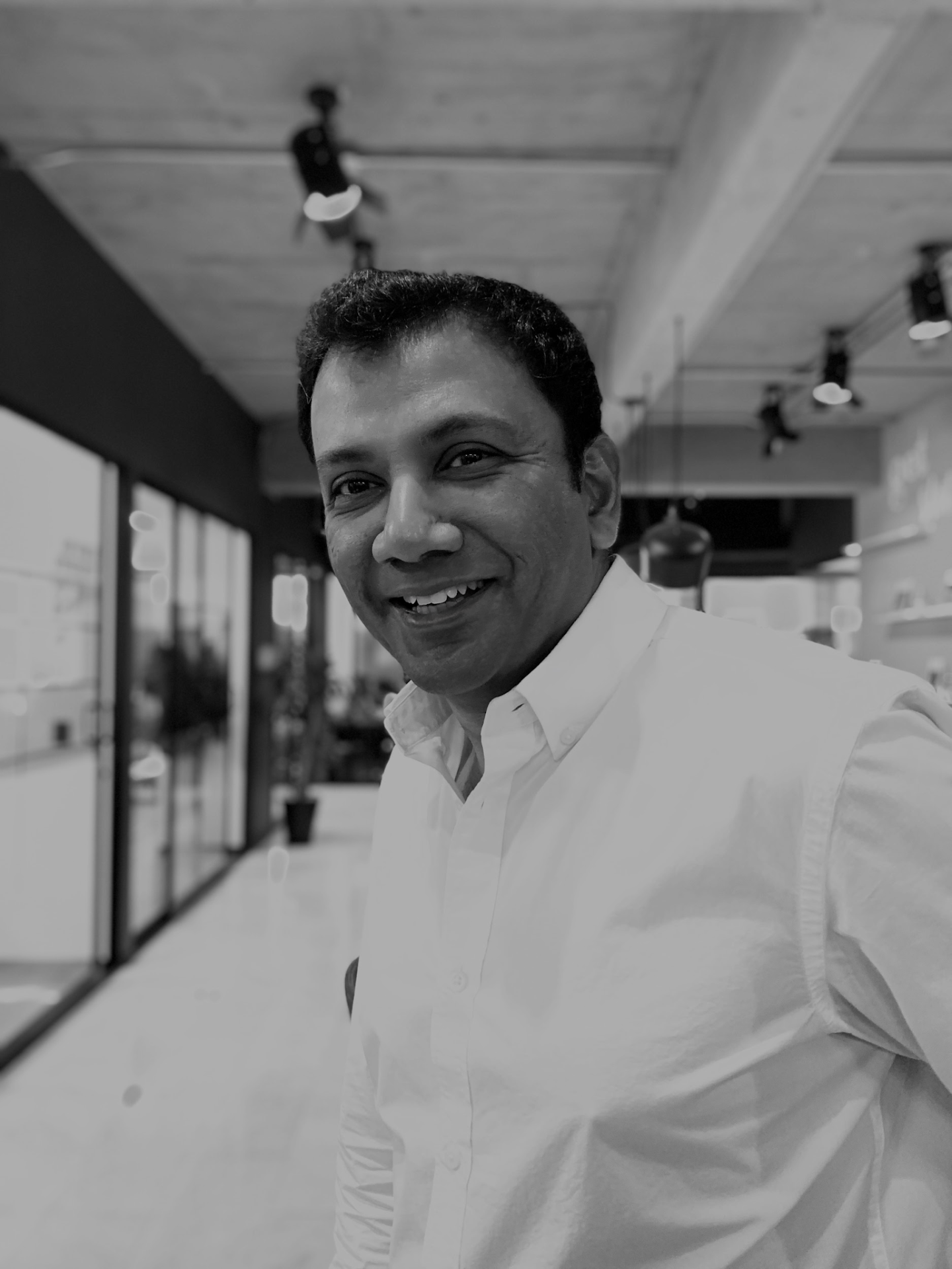 Black-and-white portrait of Vilash Poovala, CTO of OUT.LI.ER